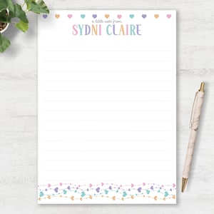 May include: A white ceramic mug with a black handle and the text "But First, Coffee" in a bold, black font. The mug is set against a neutral background, highlighting its simple design.