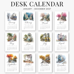 Puede incluir: Un calendario de escritorio para 2027 con doce p&aacute;ginas mensuales, cada una con una ilustraci&oacute;n &uacute;nica en acuarela de escenas callejeras europeas y paisajes estacionales, con el texto DESK CALENDAR JANUARY - DECEMBER 2027 arriba.