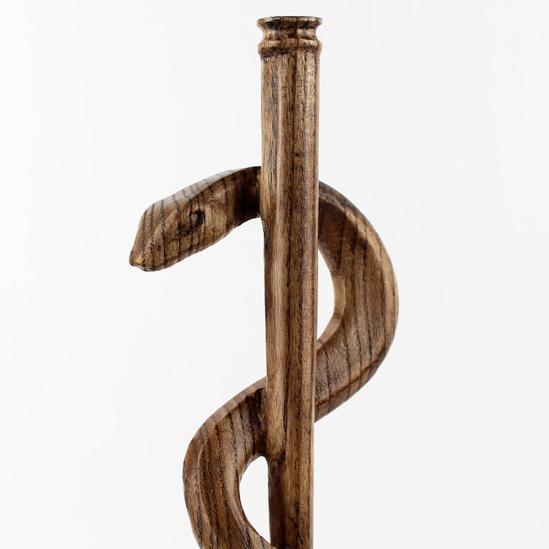 Feel the craftsmanship in your hands—this handmade wooden medical staff sculpture is carefully carved to highlight the elegance of the Rod of Asclepius. 

Lightweight yet sturdy, it’s a lasting gift for doctors, nurses, and medical students, symbolizing the wisdom and responsibility of the medical profession. A perfect White Coat Ceremony gift or physician appreciation present.