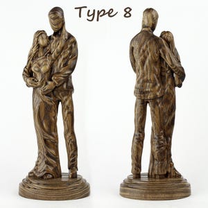 May include: A wooden sculpture of a couple embracing, with the man holding the woman close. The sculpture is made of dark wood with a natural grain pattern. The sculpture is labelled "Type 8".