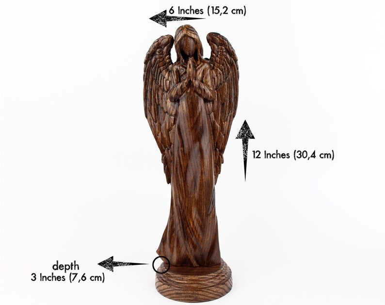May include: A wooden angel figurine with wings outstretched, standing on a round base. The angel is carved with intricate details and has a prayerful pose. The figurine is 12 inches tall, 6 inches wide, and 3 inches deep.