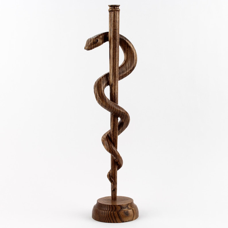 A refined medical office decoration, perfect for a doctor’s desk, hospital reception, or medical school classroom. 

This handmade wooden sculpture is more than just an artistic piece—it’s a tribute to the healing profession. 

Whether gifted for a medical graduation, White Coat Ceremony, or retirement, this Asclepius Staff statue serves as a daily reminder of the dedication and care of medical professionals.