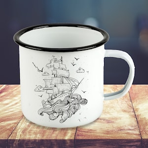May include: White enamel mug with a black rim and a black and white illustration of a ship sailing on waves. The ship has sails and a mast.