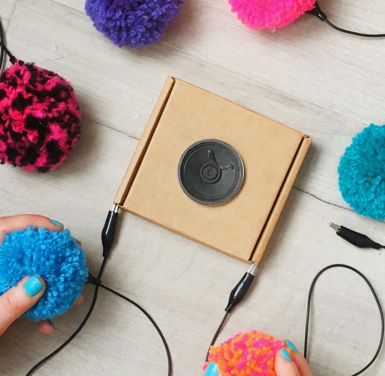 played by squeezing pompoms! DIY Pompom Musical Instrument Kit craft with e-textiles to make an electronic musical instrument