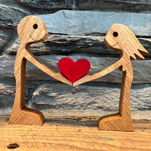 Wooden Figurines Sharing Their Love