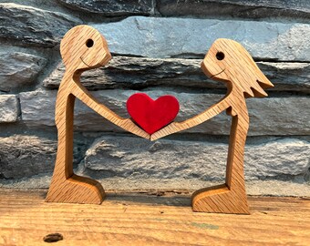 Wooden Figurines Sharing Their Love