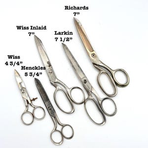 May include: A collection of vintage scissors of varying sizes, including brands like Wiss, Henckles, and Larkin. The scissors range in length from 4 3/4 inches to 7 1/2 inches. The image includes text labels indicating the brand and size of each pair.