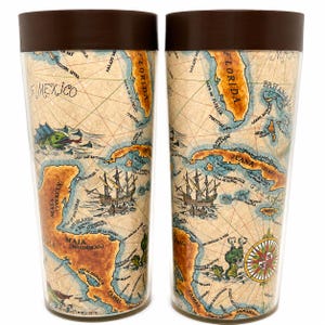 May include: Two cylindrical tumblers with dark brown lids, featuring a vintage-style map print of the Gulf of Mexico and Caribbean. The design includes illustrations of sailing ships, sea creatures, and a compass rose on a tan background.