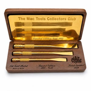 May include: A set of three 24k gold-plated chisels housed in a dark wood display box. The interior lid features a gold plate with the text The Mac Tools Collectors Club Limited Edition Gold 1997. The base includes the text 24k Gold Plated, Made in USA, Limited Edition 1997 - Gold, Mac Tools, and Serial Number 1679.