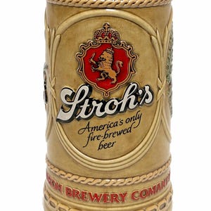 May include: Tan ceramic beer stein with the Stroh's logo, a red shield with a lion and crown. The stein has a rope-like design around the top and bottom, with the text "America's only fire-brewed beer."