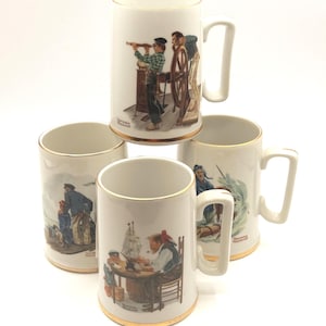 May include: Set of five white ceramic mugs with gold trim and handles. Each mug features a different nautical-themed illustration, including sailors, ships, and ocean scenes. The mugs are likely collectible items.