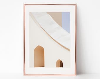 May include: A framed photograph of a white building with two arched doorways. The building has a curved roof and a light blue wall in the background.