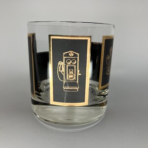 May include: A clear glass tumbler with black and gold designs. The design features a vintage-style telephone with a rotary dial.