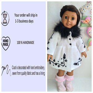 May include: White coat with black faux fur trim and black embroidery for a doll. The coat has a lining and is handmade.