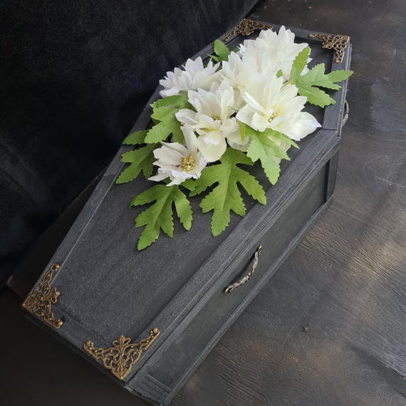 A real woodworker built a miniature coffin with lace-lined stretcher stand — equal parts morbid curiosity cabinet piece and functional trinket box.