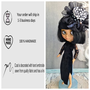 May include: A black doll with black hair and a black velvet dress. The doll is wearing a black and white polka dot hat with a black veil. The doll is standing on a blue and white surface.