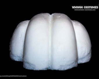 May include: White foam headpiece with three rounded sections, resembling a crown or a helmet.