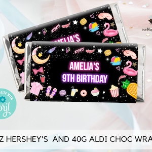 May include: Two black and silver chocolate bar wrappers with a pink and blue tropical theme. The wrappers feature a moon, stars, and the text "Amelia's 9th Birthday".