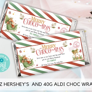 May include: Two Hershey's chocolate bar wrappers with a Christmas theme. The wrappers feature a red and green striped design with the text "Merry Choco-Mas" and a Santa Claus illustration. The wrappers are personalized with a name and address.