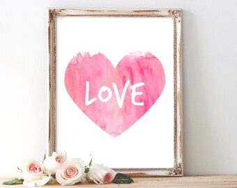 May include: A pink watercolor heart with the word "LOVE" written in white inside. The heart is framed in a white distressed frame.