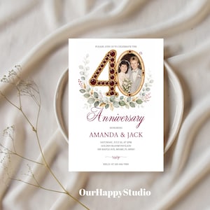 May include: A 40th anniversary invitation card featuring a large number 40 decorated with red gems, an oval photo frame with a couple, and watercolor eucalyptus leaves. Text includes: PLEASE JOIN US TO CELEBRATE THE 40th Anniversary AMANDA & JACK.