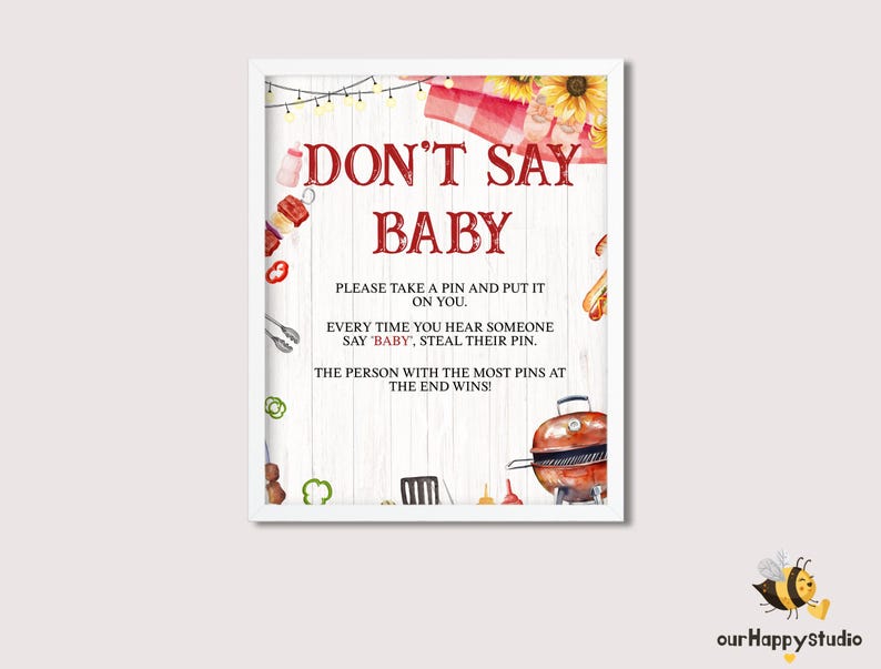 Op de afbeelding: Een wit bord met een rood-wit geruite achtergrond en een rode rand. Het bord zegt "Don't Say Baby" en bevat instructies voor een spel. De instructies zeggen om een ​​pin te nemen en deze op jezelf te bevestigen, elke keer dat je iemand "baby" hoort zeggen. De persoon met de meeste pinnen aan het einde wint.