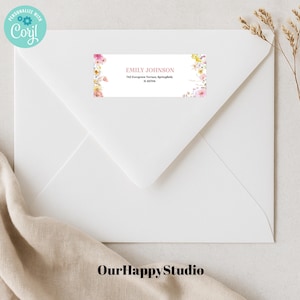 May include: A white envelope with a floral return address label. The label has the text "Emily Johnson" and an address. The envelope is on a beige surface.