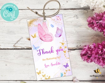 May include: Purple and pink butterfly thank you tag with gold glitter and the text "Thank you for fluttering by! Love, Scarlettte".