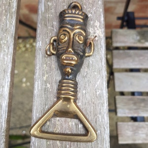 vintage antique 1930s souvenir bottle opener tribal heavy brass piece bar ware unusual design pattern boho retro