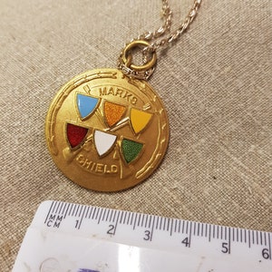 vintage art deco shooting medal pendant piece kitsch retro gold tone item jewellery piece 1950s 60s