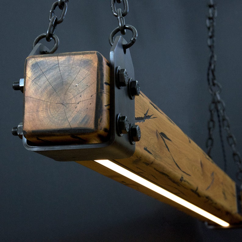 May include: A rustic wooden pendant light fixture with a metal frame and chain. The light features a warm white LED strip.