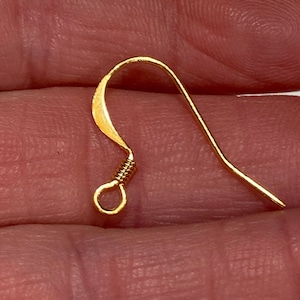 May include: Gold-toned earring hook with a wire loop at the top. The hook is made of metal and has a smooth, polished finish.
