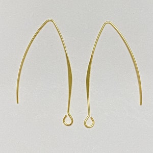 May include: Two gold-toned earring hooks with a curved shape and a small loop at the bottom.