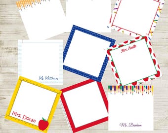 May include: A collection of nine square note pads featuring various school-themed designs including yellow pencils, paper clips, colorful crayons, alphabet letters, red apples, lined paper, and rulers, with some pads personalized with names like Mrs. Smith.