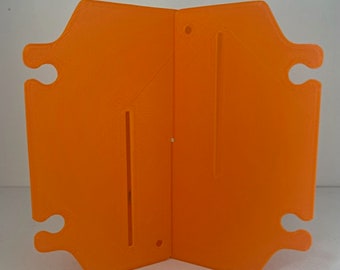 May include: Orange plastic divider with two slots and four holes. The divider is folded in half.