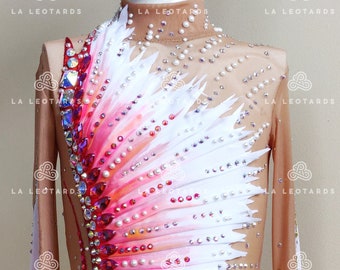 May include: A white and pink leotard with a feathered design and rhinestones. The leotard has long sleeves and a high neckline.