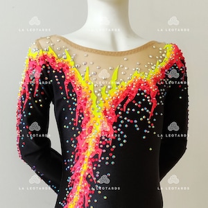 Puede incluir: Leotardo negro de manga larga con un dise&ntilde;o de llama colorido. El dise&ntilde;o presenta pedrer&iacute;a rosa, amarilla y azul.