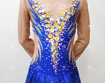 May include: A blue and gold leotard with a sheer long-sleeved bodice and a short skirt. The leotard is decorated with rhinestones and sequins.