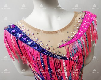 May include: A pink, blue, and white leotard with fringe and rhinestones. The leotard has a scoop neck and a mesh fabric.