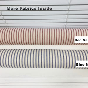 May include: Two rolls of striped fabric, one red and white, the other blue and white. The text "Red Natural" and "Blue Natural" is printed on the fabric rolls.
