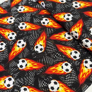 Goal! - Flaming Soccer Balls Fabric by Gail Cadden - Cotton Fabric