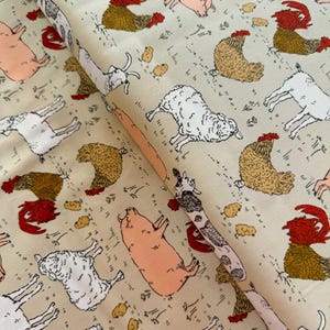 May include: Cream-coloured fabric with a repeating pattern of farm animals. The design includes illustrations of pigs, sheep, chickens, and cows in various poses, with small yellow shapes and grass details.