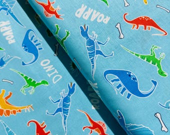 Świecący w ciemności - Glow-O-Saurus - Dino Friends Aqua Fabric by Kanvas Studio - Tkanina bawełniana