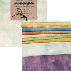 Op de afbeelding: Een stapel handgekleurde wollen stofstalen in verschillende kleuren, waaronder geel, oranje, groen, blauw en paars. De stof is van Primitive Gatherings, een bedrijf dat handgekleurde wollen stof verkoopt.