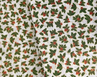 May include: White fabric with a repeating pattern of green holly leaves and red berries.