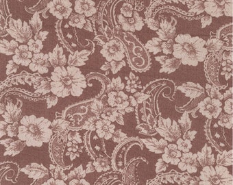 May include: A brown fabric with a white paisley and floral pattern. The fabric has a textured surface.
