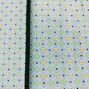 May include: A blue fabric with a repeating pattern of yellow stars, green leaves, and black dots. The pattern is a stylized floral design.
