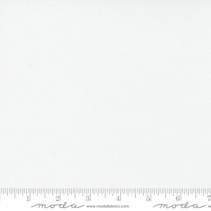 May include: A plain white fabric with a subtle texture. The fabric is measured with a ruler that has the word "moda" printed on it.