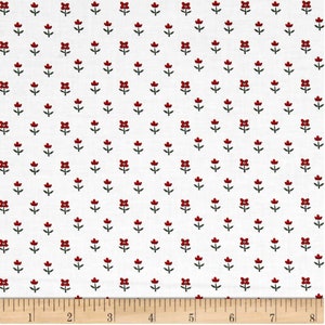 May include: White fabric with a repeating pattern of small red flowers with green stems.