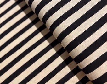 May include: Black and white striped fabric with a subtle texture. The fabric is folded in half, showing the stripes running in two directions.